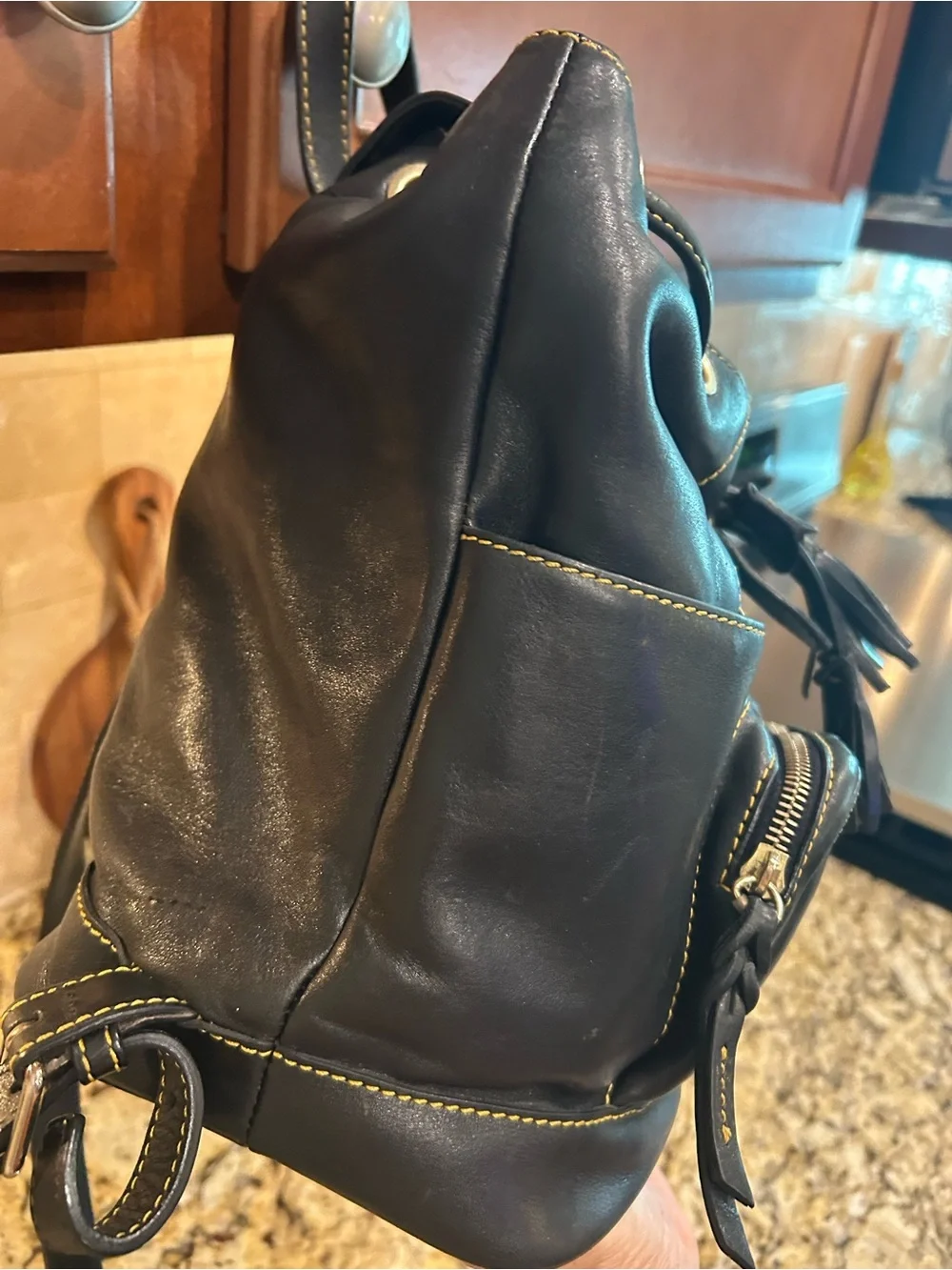 Dooney & Bourke Black Leather Drawstring Backpack with Yellow Stitching
